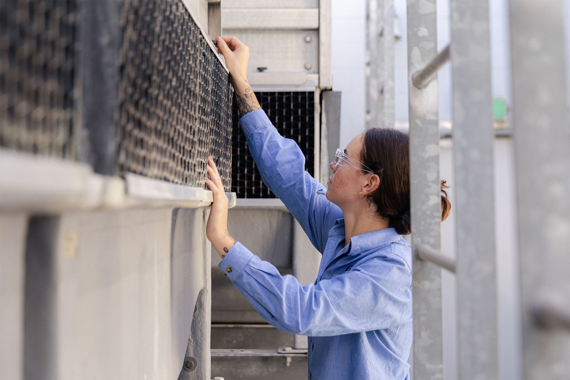 An MPS HVAC Technician preforming routine maintenance on a commercial HVAC system